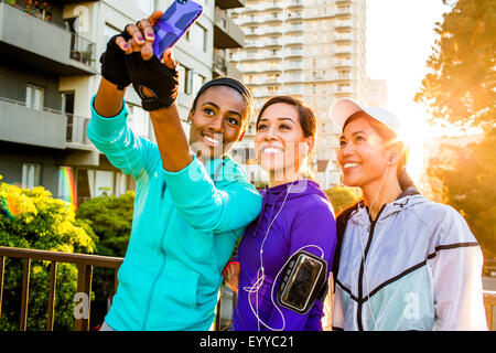 Runners taking selfie in city Stock Photo