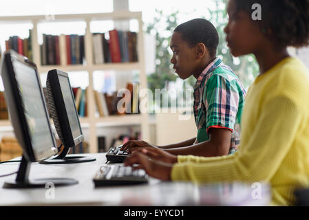 Black students using computers in classroom Stock Photo