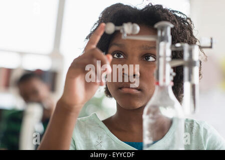 Black student doing experiment in science lab Stock Photo