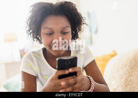 Close up of Black girl using cell phone Stock Photo