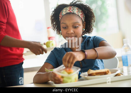 Black students eating lunch in school cafeteria Stock Photo