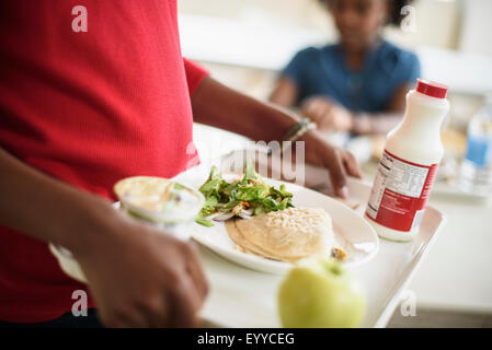 Black students eating lunch in school cafeteria Stock Photo