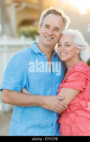 Older Caucasian couple walking on beach Stock Photo