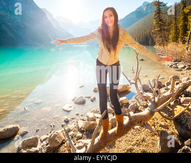 Caucasian girl balancing on log at Lake Louise, Banff, Alberta, Canada