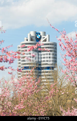 BMW headquarters high-rise tower office building in spring blossoming Olympiapark. Stock Photo