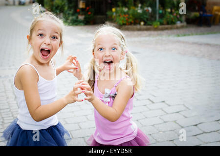 Two little sisters shouting. Selective focus. Stock Photo