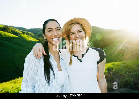 Women smiling on rural hilltop Stock Photo