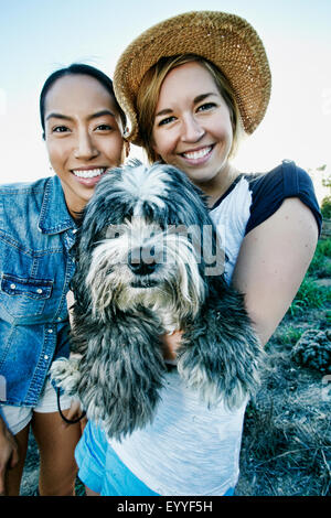 Close up of women smiling with dog Stock Photo