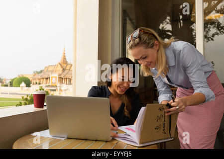 Businesswomen working together in cafe, Phnom Penh, Cambodia Stock Photo