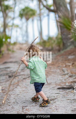 Caucasian baby boy walking on dirt path Stock Photo