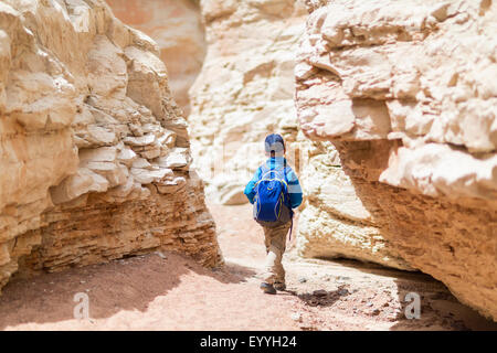 Boy exploring desert rock formations Stock Photo