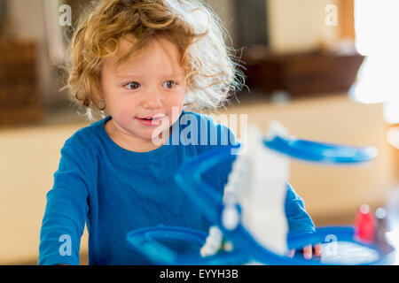 Caucasian baby boy playing with toy in living room Stock Photo