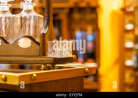 glasses and decanters for wine on a wooden stand in retro style Stock Photo