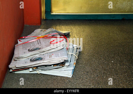 newspapers in an entrance, Germany Stock Photo
