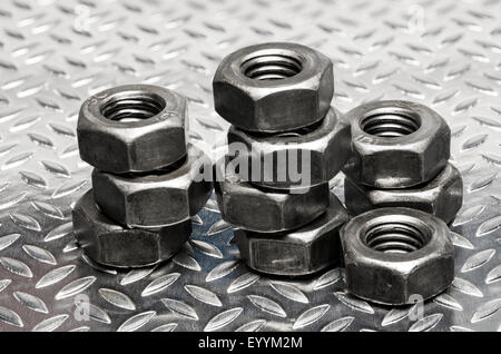 Metric thread Nuts arranged in stacks. Stock Photo