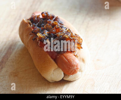 A hot dot with mustard, ketchup and sautéed onions Stock Photo