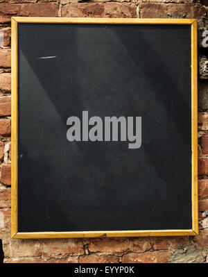 Empty blackboard on brick wall, free space for some text Stock Photo