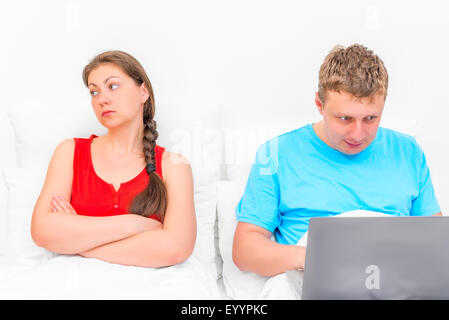 offended the wife with her husband playing computer games Stock Photo