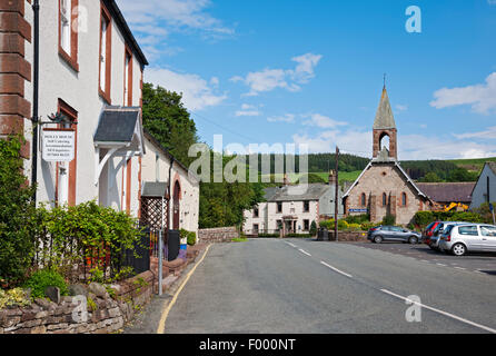 Looking along the main street Pooley Bridge village near Ullswater in summer Cumbria England UK United Kingdom GB Great Britain Stock Photo