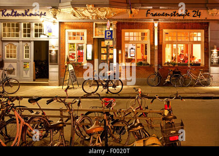 bicycles in front of inn 'Kulturkneipe' in Muenster, Germany, North Rhine-Westphalia, Muensterland, Munster Stock Photo