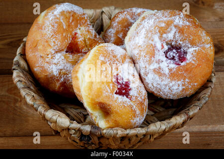 donuts with jam in a wicker basket Stock Photo