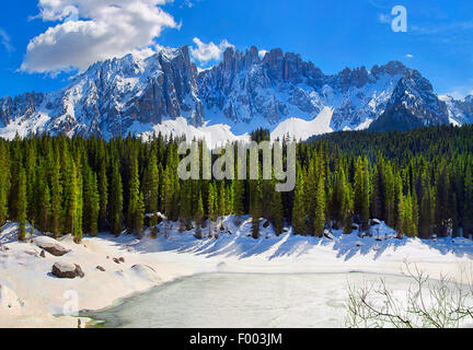 Latemar and frozen Karersee, Lago di Carezza, in early spring, Italy, Latemar-Gruppe Stock Photo