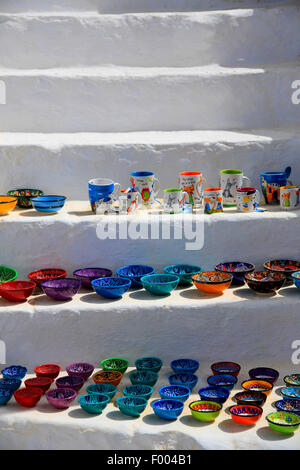 coloured ceramic dishes and cups on a white stone stair, souvenirs, Greece, Cyclades, Santorin, Thira Stock Photo