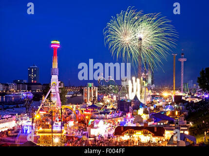 biggest funfair on the river Rhine with firework in the evening, Germany, North Rhine-Westphalia, Duesseldorf Stock Photo