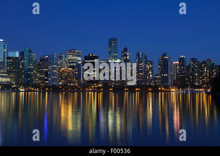 view from Stanley Park to the high-rise buildings of Vancouver at night, Canada, Vancouver Stock Photo