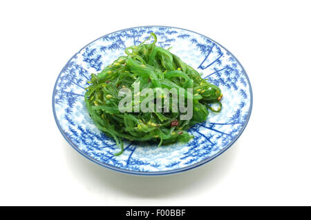Japanese green seaweed salad on dish Stock Photo