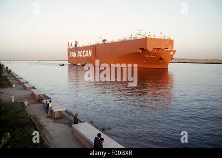 Suez Canal, Egypt - A car transport ship the Pan Ocean exits the southern end of the Suez Canal before it empties into the Red sea.  One of the marvels of engineering constructed in 1869 by Frenchman Ferdinand de Lesseps, it is today undergoing a signficant upgrade by adding a parallel canal to increase two-way shipping traffic and lessen waiting times. Stock Photo