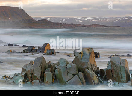 stormy coastline and snowy peaks, fjells along coast, Barentz sea, Norway, Varangerfjord Stock Photo