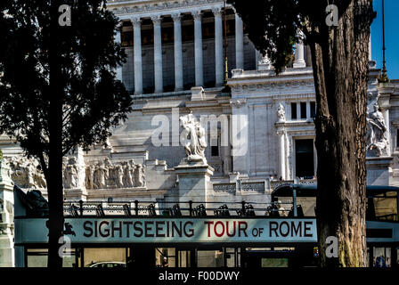 Sight seeing tour of Rome bus in front of the National Monument to Victor Emmanuel II. Rome, Italy. Stock Photo