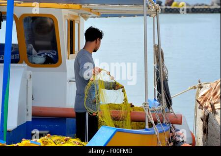 A fisherman tending to his nets. Santorini Greece Stock Photo