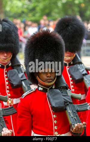 A Black Soldier of The Grenadier Guards marching along The Mall at The Queen's Birthday Parade or Trooping The Colour ,The Mall , London ,UK Stock Photo