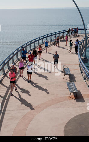 Runners and walkers on the Brant Street Pier, Burlington, Ontario, Canada. Stock Photo