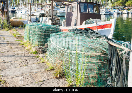 Fishing creels on the pier in the background fishing boat Stock Photo