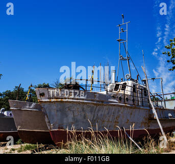 Deserted rusty ship on the coast Stock Photo