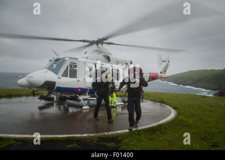 Tourists landed in Mykines using the helicopter of Atlantic Airways. Faroe Islands Stock Photo