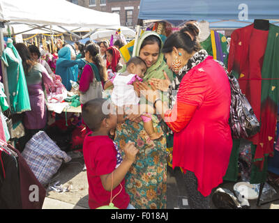 Tender moment at Bangladeshi street fair and festival in 'Little Bangladesh,' in the Kensington section of Brooklyn, New York. Stock Photo