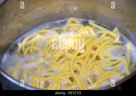 boiling of pasta in a saucepan with water boiling Stock Photo