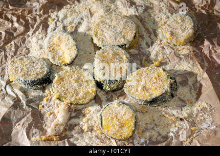 slices of breaded eggplants ready to be fried Stock Photo