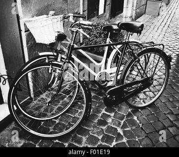 Two classic vintage retro city bicycles, bw photo, Rome, Italy Stock Photo