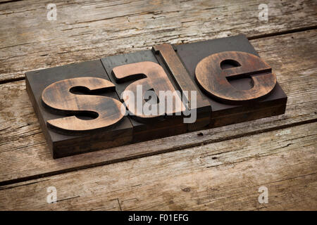 sale, word written with vintage letterpress printing blocks, angled view, rustic wooden background Stock Photo