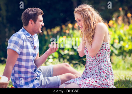 Handsome man doing marriage proposal to his girlfriend Stock Photo