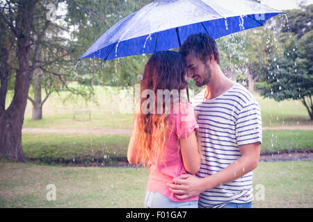 Cute couple hugging under the umbrella Stock Photo