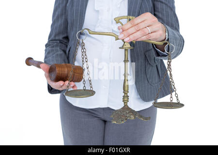 businesswoman holding scales of justice Stock Photo