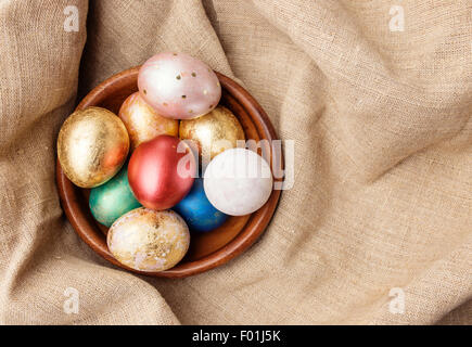 Painted Easter Eggs  in decorated green basket on wooden table. Holiday background Stock Photo