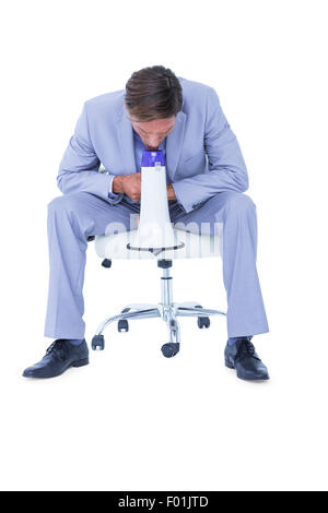 Businessman talking through megaphone Stock Photo