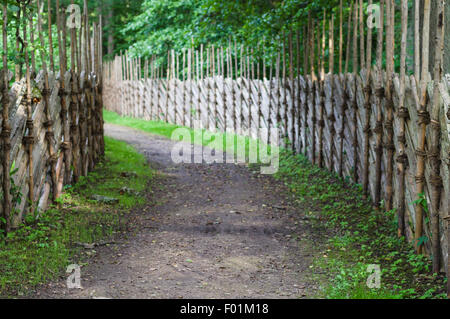 Defocused background of turning footpath between decorative wooden fences Stock Photo